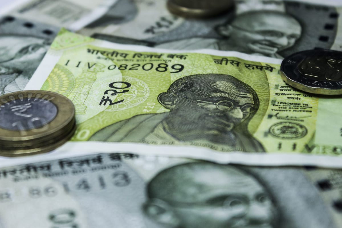 Close-up of Indian rupee banknotes and coins, representing the statutory cost of registering a property in Bangalore.